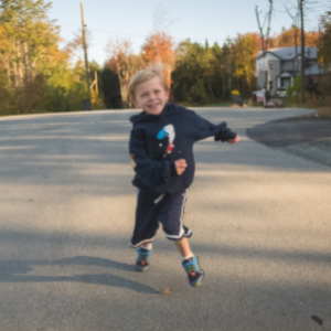 image of child running and smiling